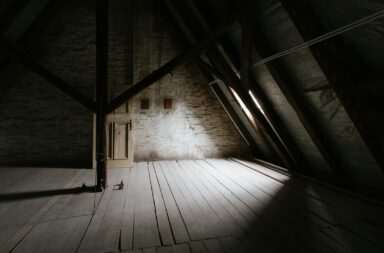 a wooden walkway with a light at the end